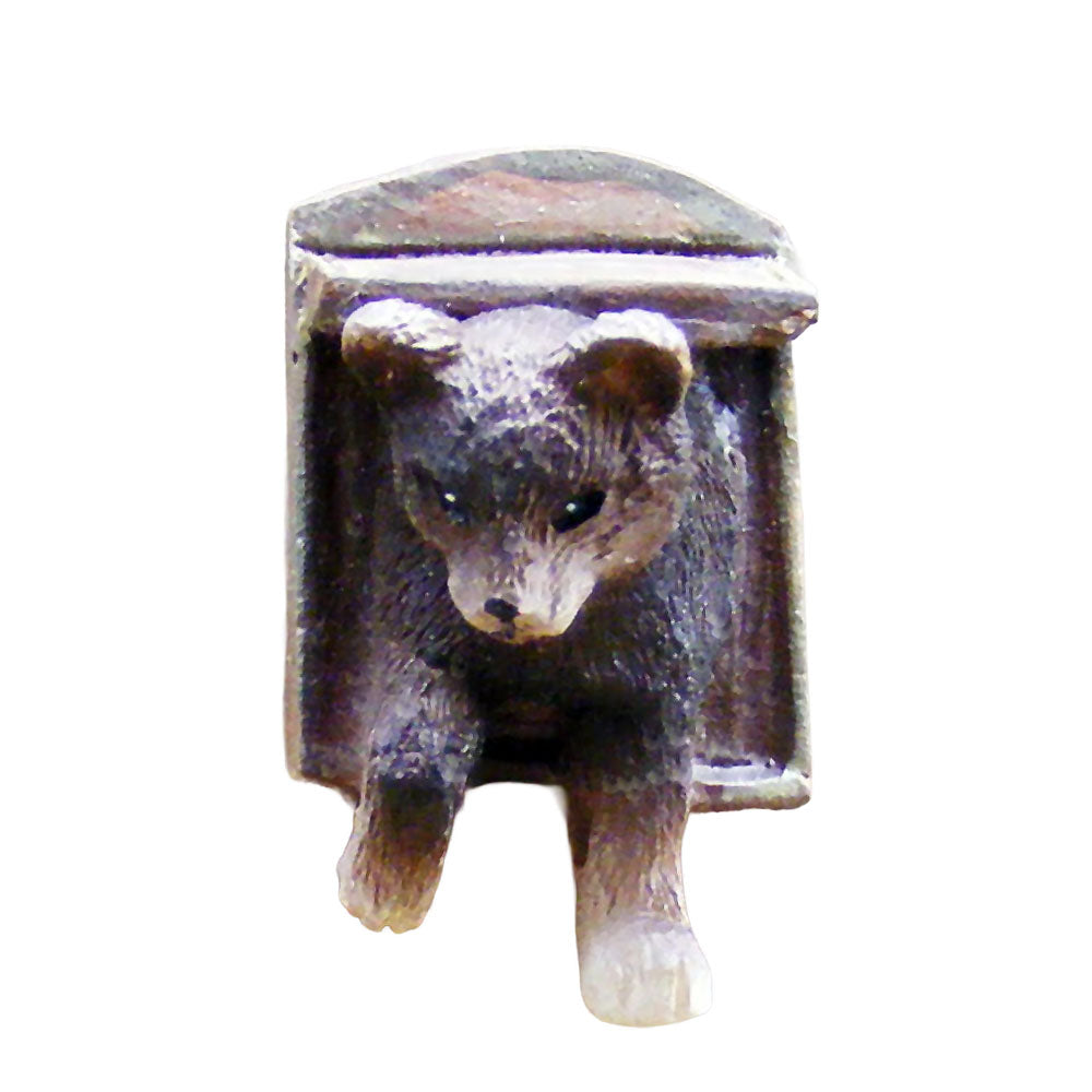 Small miniature figurine of a cat using a cat flap