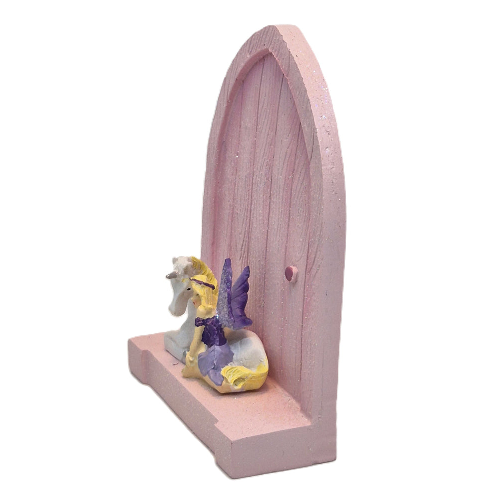 Side view of pink fairy door with fairy and unicorn figurine on base - Earth Fairy