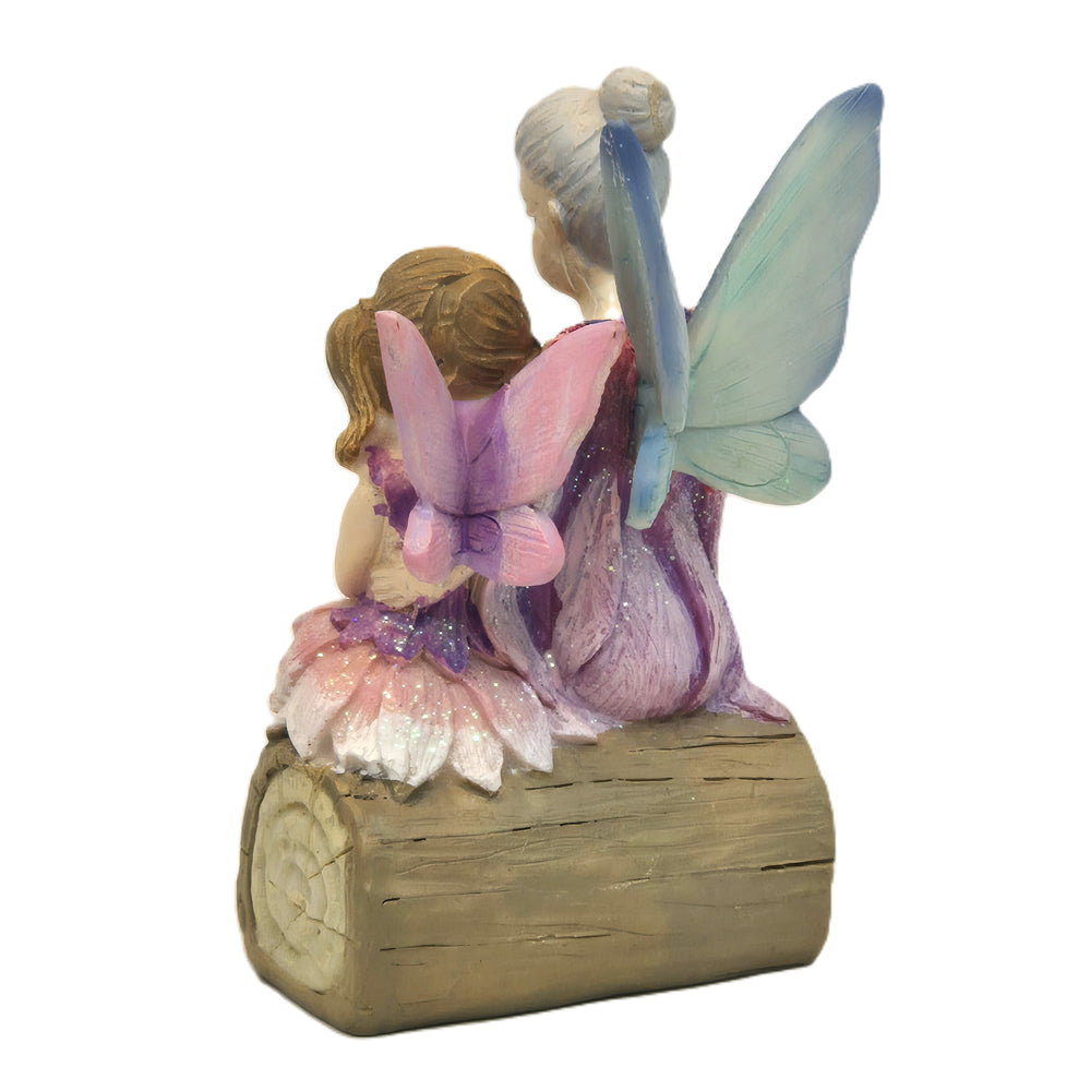 Rear view of fairy grandmother and granddaughter figurine showing blue and pink wings on log - Earth Fairy