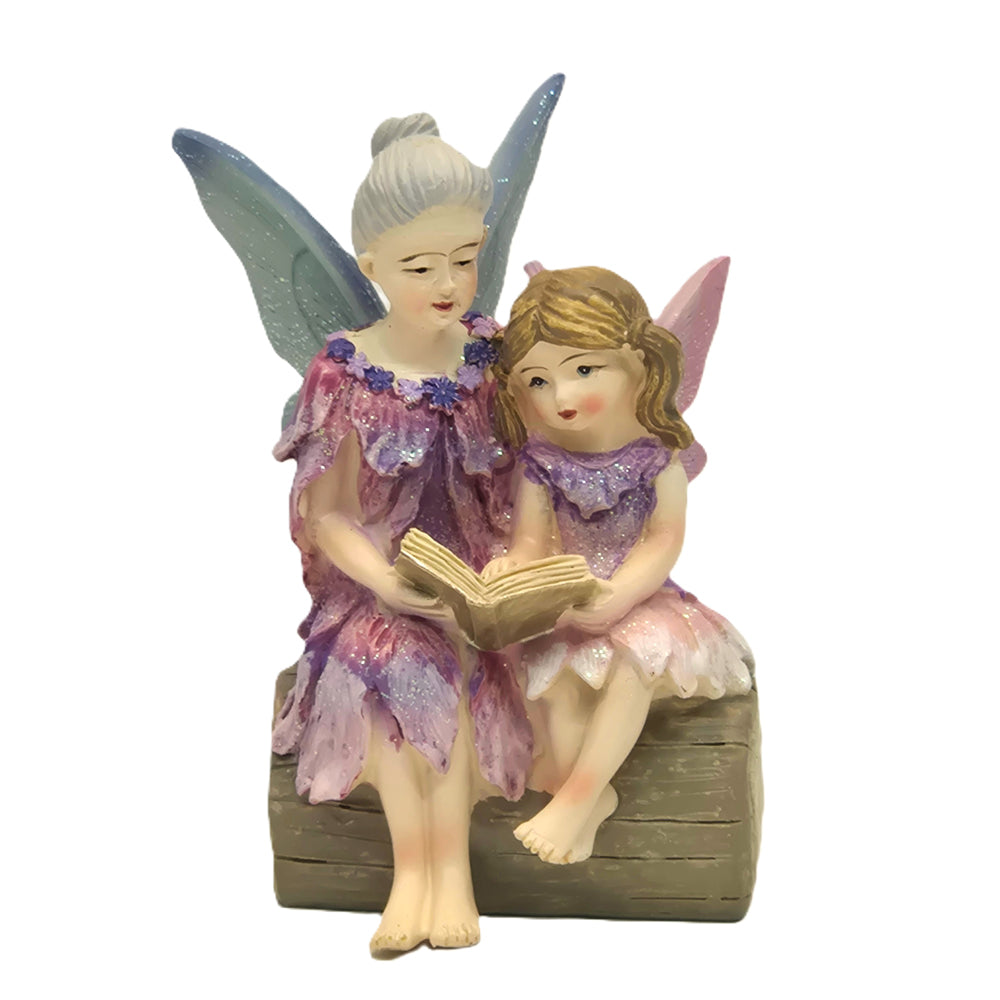 Fairy grandmother with silver hair reading to granddaughter on log - hand painted resin figurine