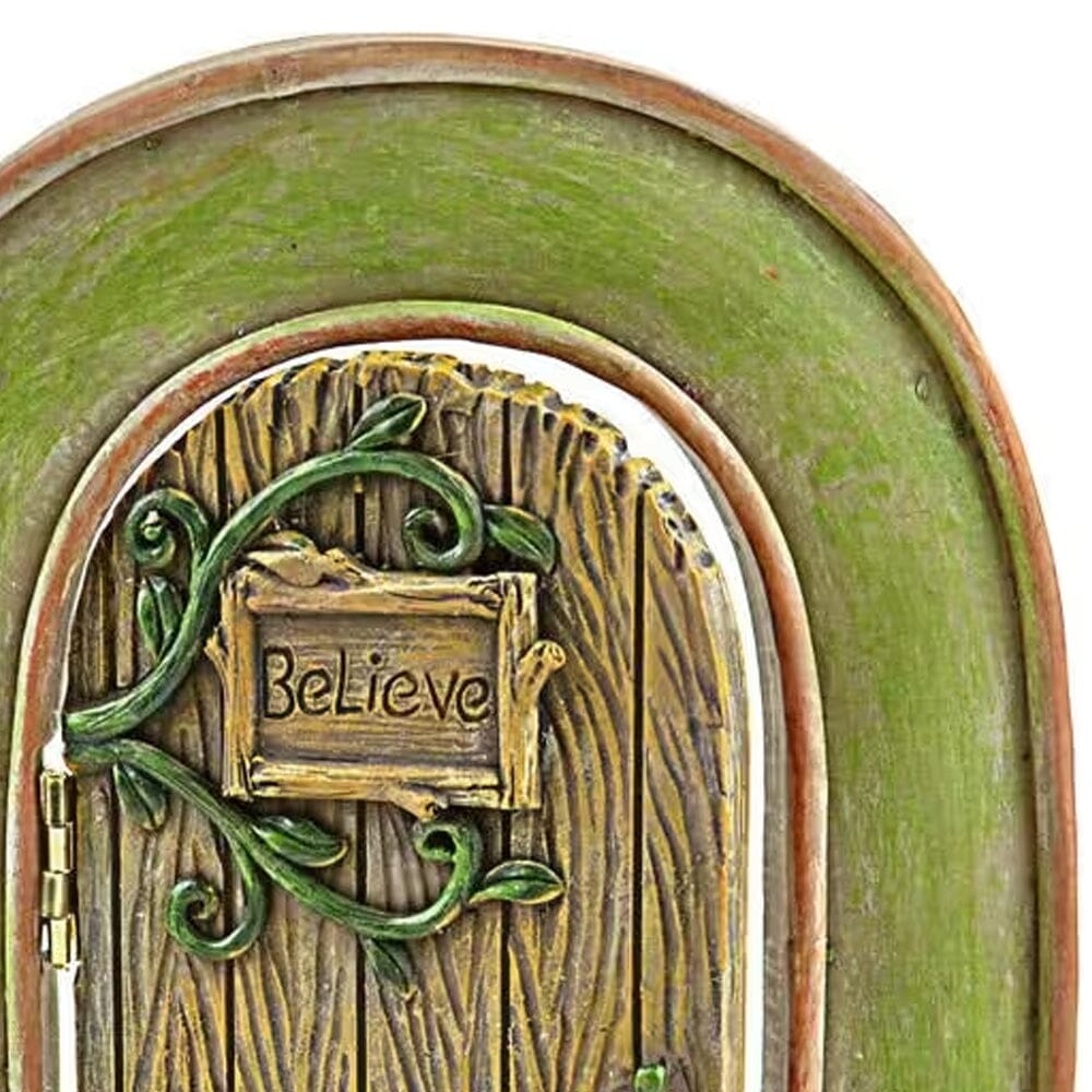polyresin opening fairy door, featuring an arch with swinging, opening door, with a plaque with the word believe enscribed upon it