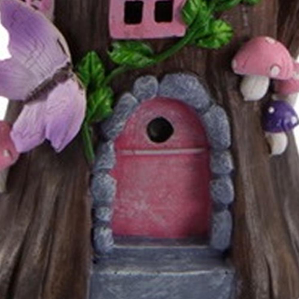 Close up of pink arched door of the Enchanted Rose Fairy Cottage