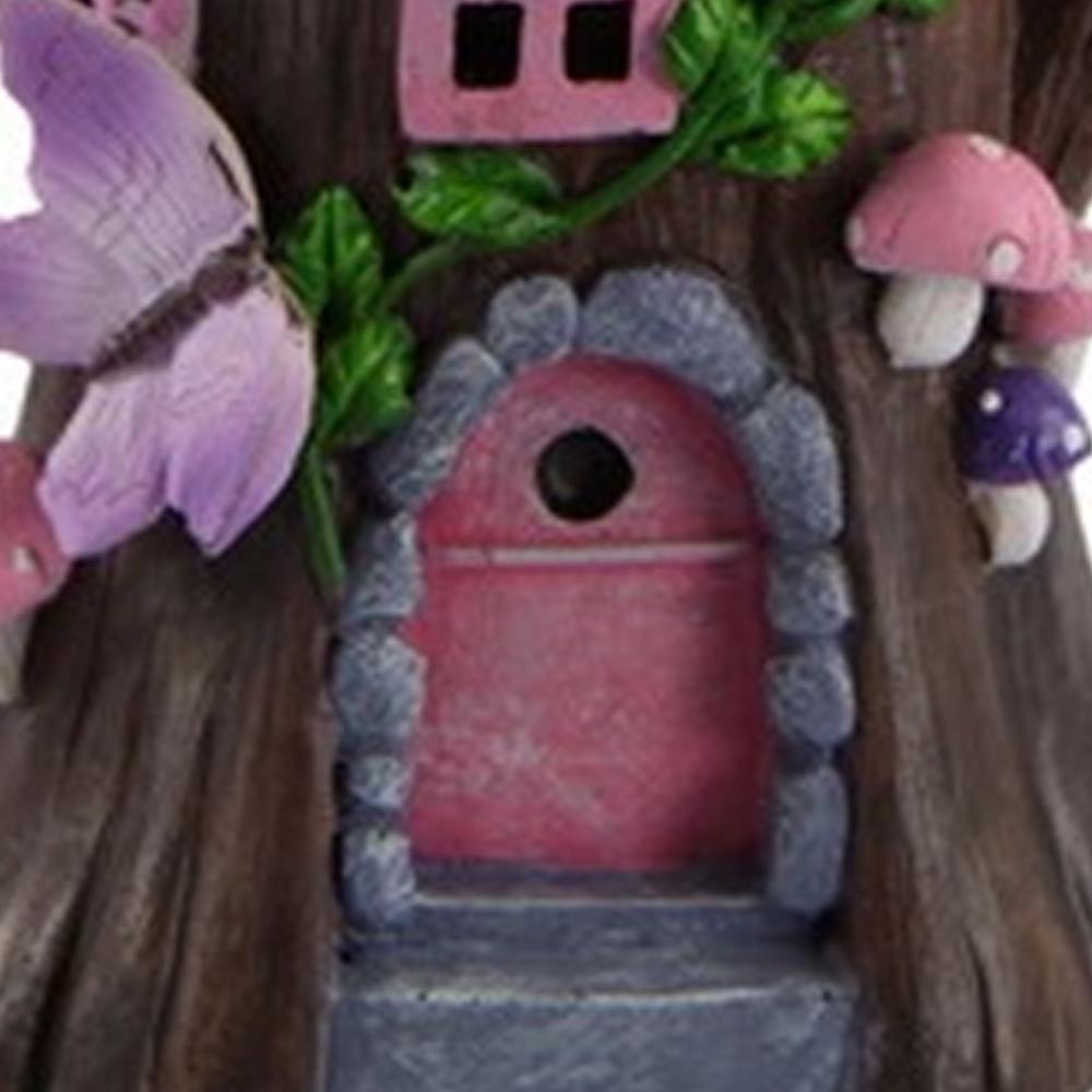 Enchanted Rose Fairy Cottage - a miniature fairy house with tree trunk like base and clusters of roses for the roof
