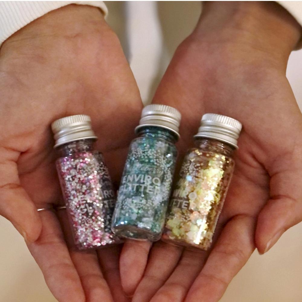 Enviro Glitter displayed in a white, heart shaped dish, shown in the "Starry Night" colourway, a mixture of blues and silver