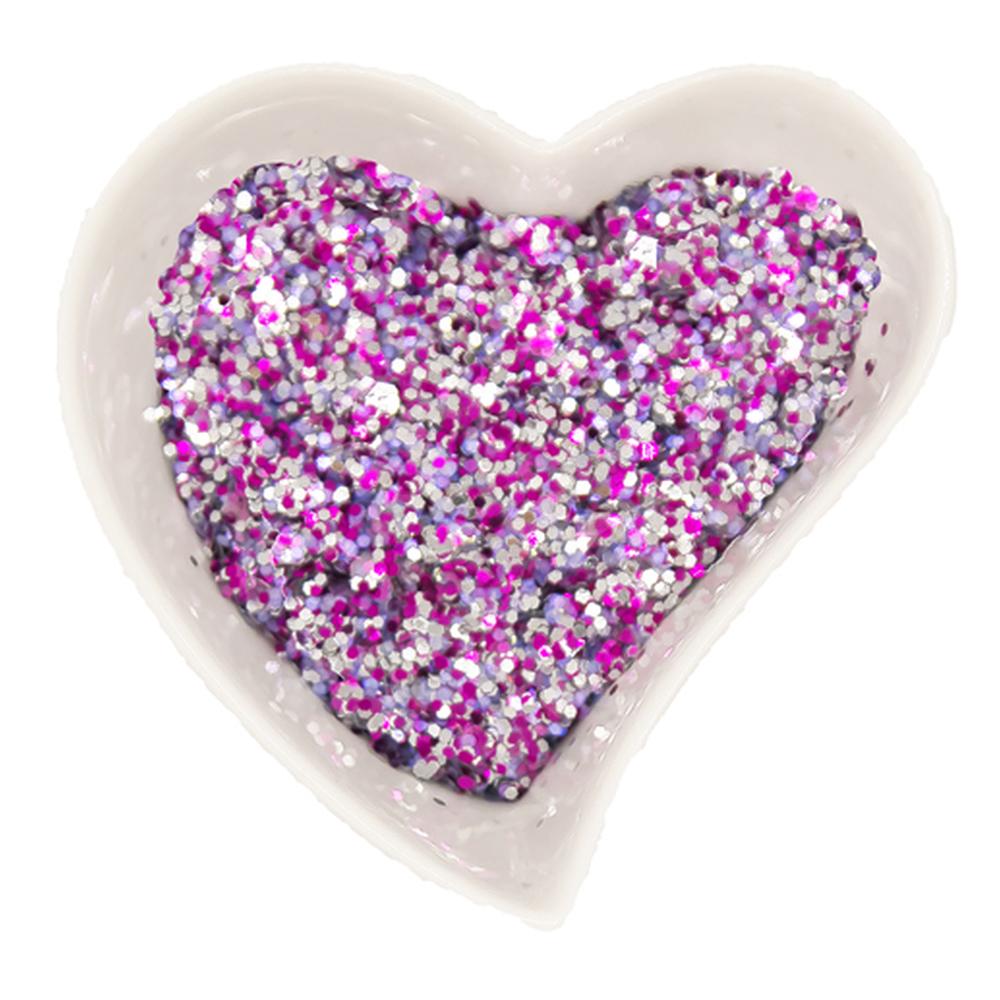 Enviro Glitter displayed in a white, heart shaped dish, shown in the &quot;Tickled Pink&quot; colourway, a mixture of pinks and silver