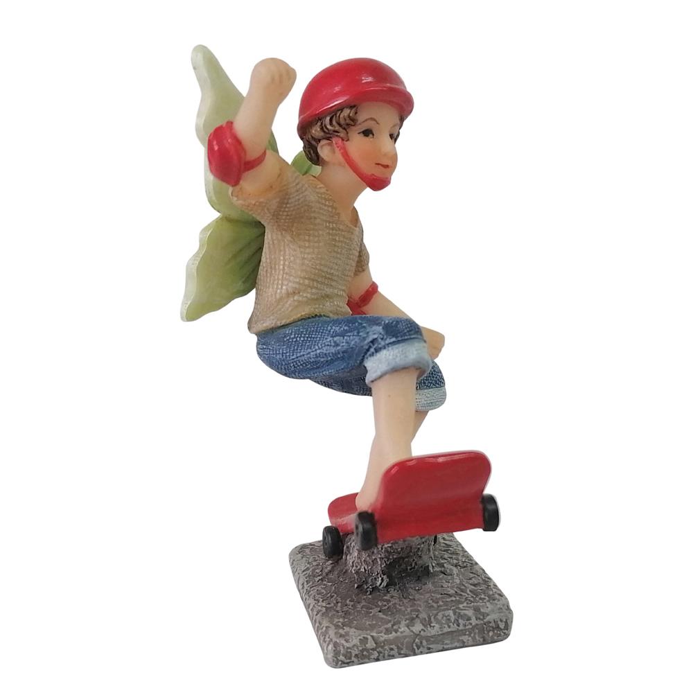 Side view of Fairy Noah Riding a Skateboard depicting a boy fairy in jeans and tshirt balancing on a red skateboard