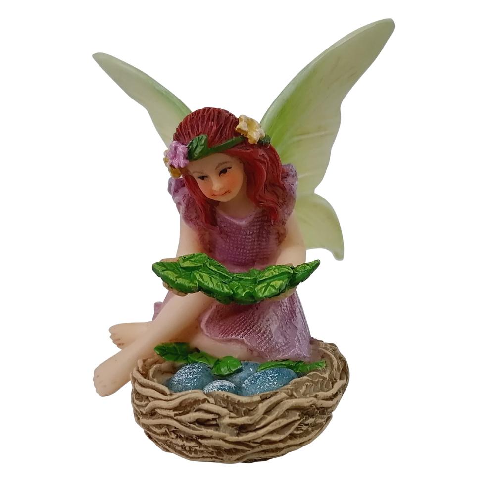 Fairy Willow with Bird Nest - a miniature resin fairy garden figurine depicting a fairy atop a nest with eggs