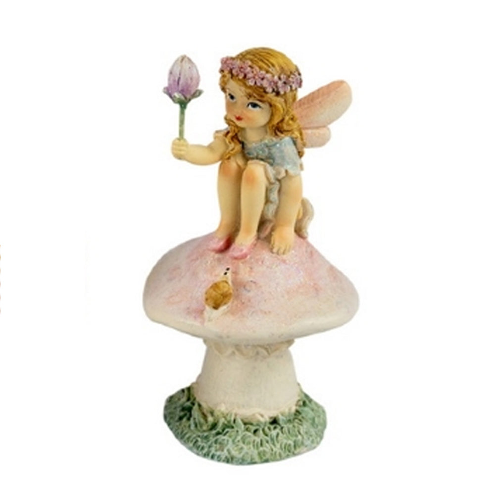 Close up view of Flower Garden Fairy Sitting on Mushroom with Flower