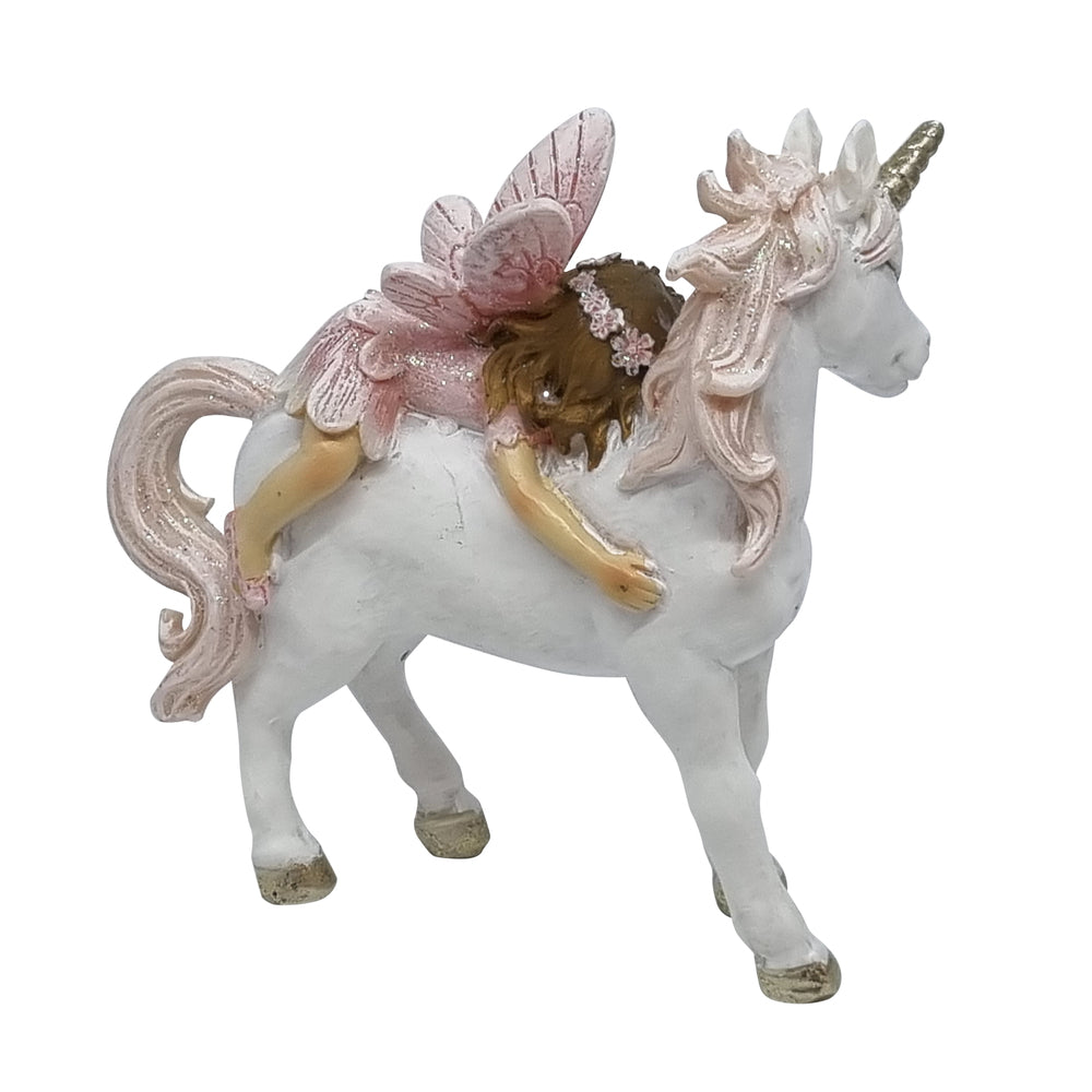 Side view of miniature fairy riding a unicorn figurine