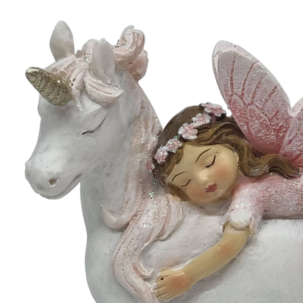 Close up view of miniature fairy riding a unicorn figurine