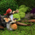 Miniature Garden Gnome Playing Horn on a Mushroom displayed on a white background