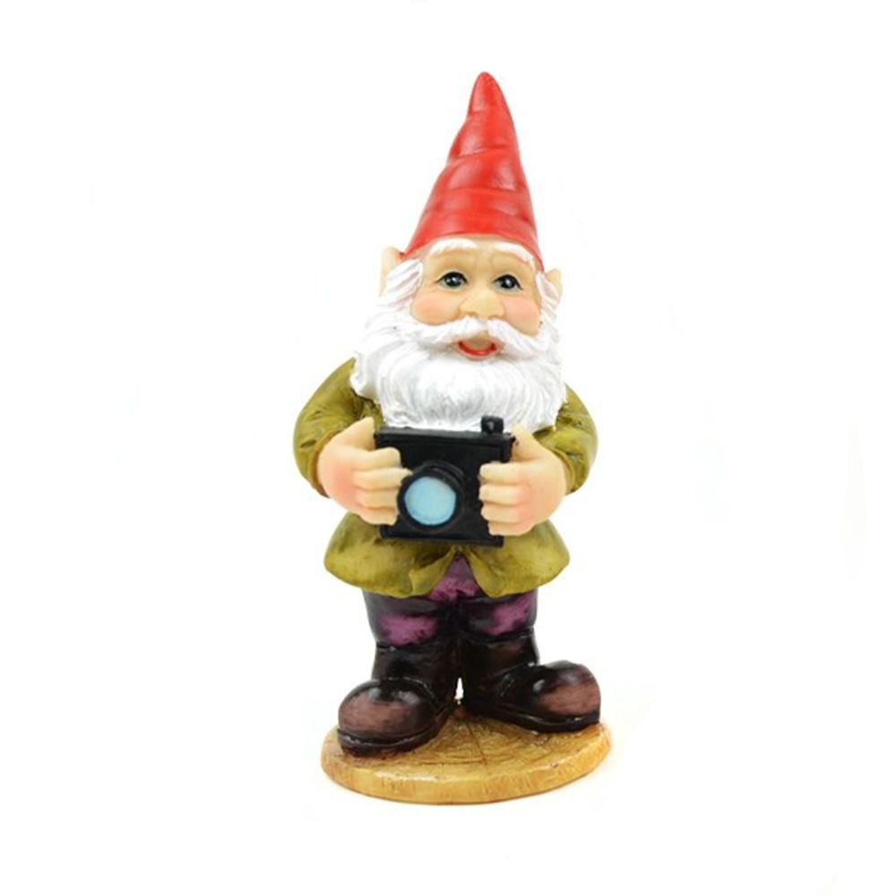 miniature polyresin gnome, brown boots, purple pants, green coat with red hat holding a camera