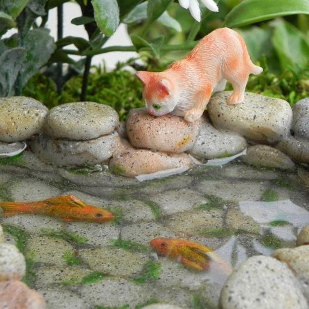 Heart Shaped Koi Pond, a miniature polystone pond accessory for a fairy garden, cobbled stone walls with water effect inside pond, with two orange koi fish swimming
