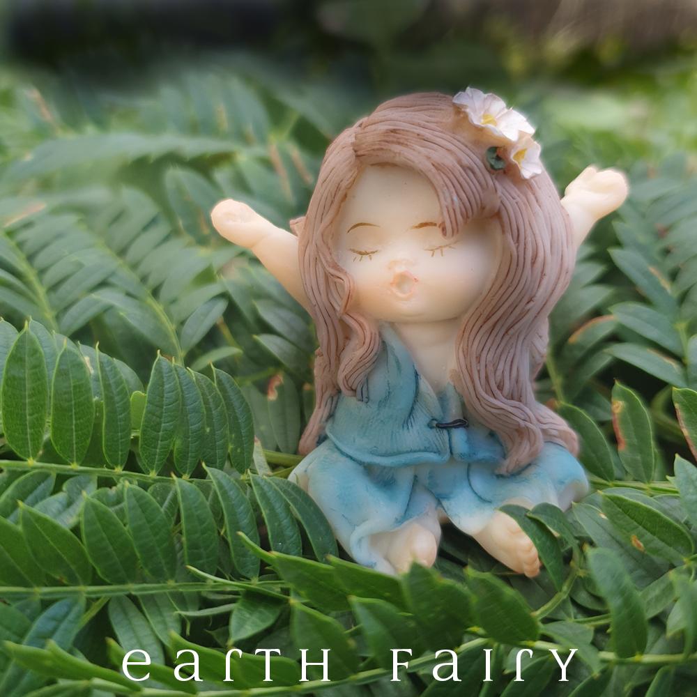 Little Fairy Yawning, small fairy with a blue/green dress, arms outstrecthed, eyes closed, and yawning.