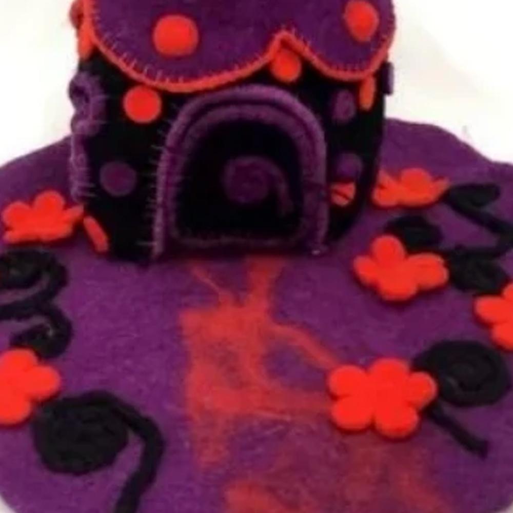 Close Up View of the Magical Faery Home, a fairy house crafted from felt, in purple and pink tones, displayed on a white background