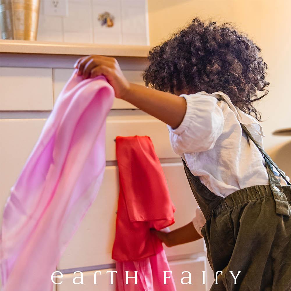 Mini Playsilk, showing child playing with kitchen drawers to make cubby,, from The Earth Fairy Silk Collection