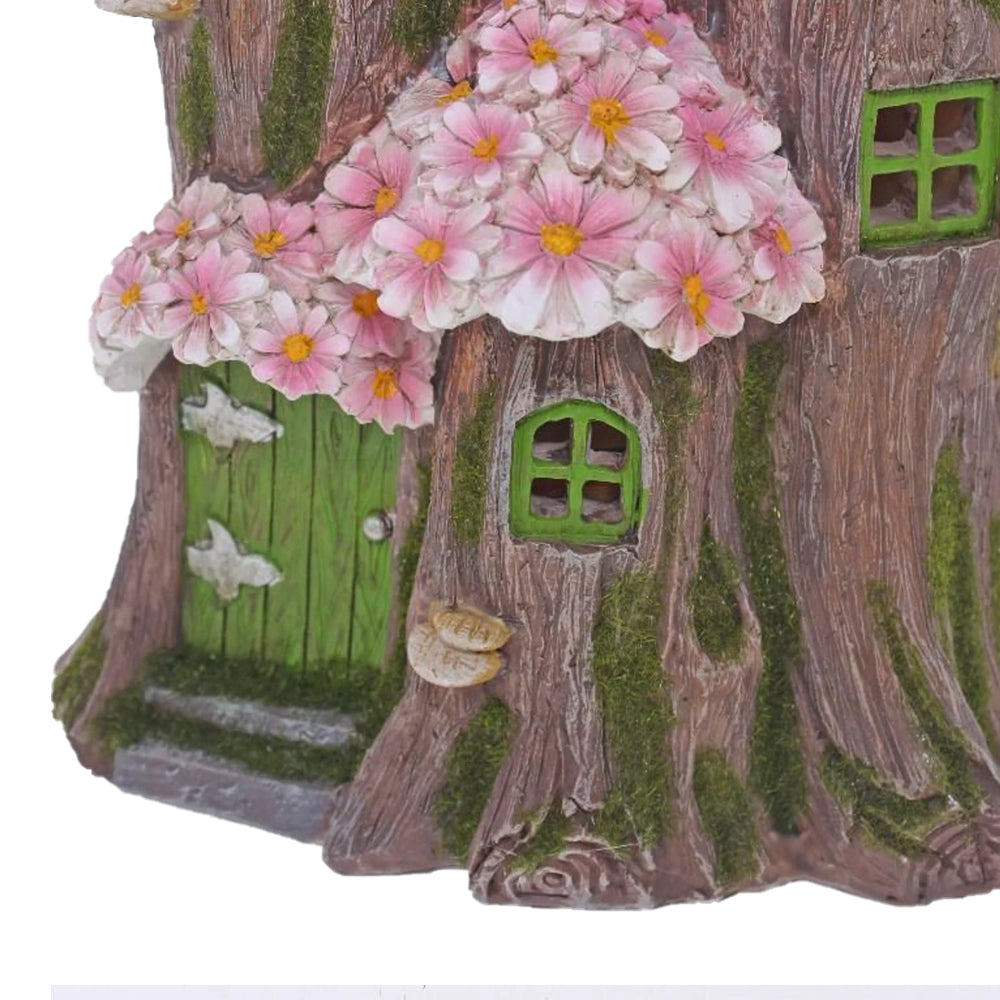 Pink Flower Tree House, a miniature fairy house for the garden, crafted from resin, featuring a treelike base with pink flowered roof, displayed on a white background