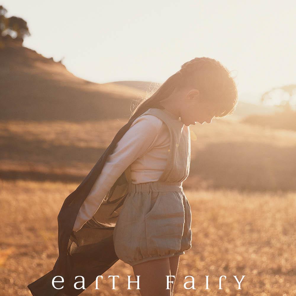 Playsilk, 90cm Square, Black, showing child playing in a field, from The Earth Fairy Silk Collection