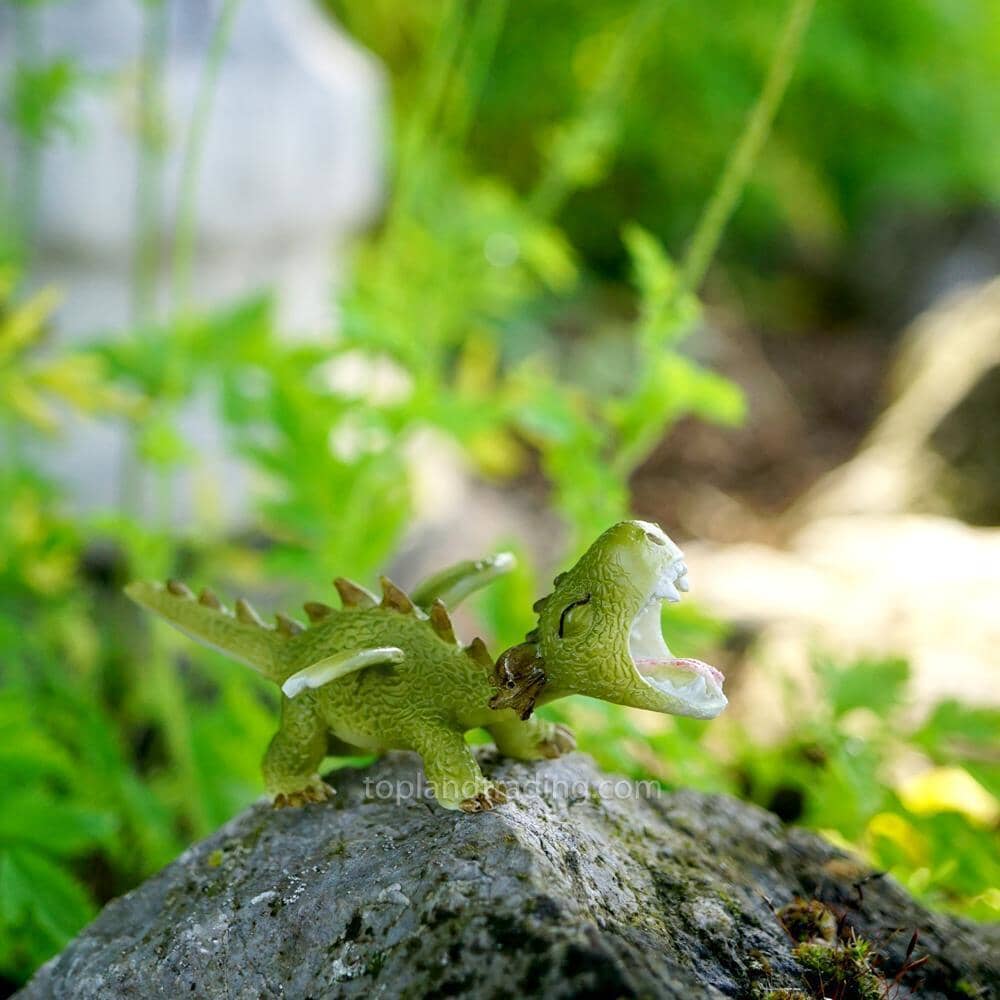 Green Dragon Roaring - Standing - a miniature resin dragon figurine for the fairy garden, displayed on a tree branch