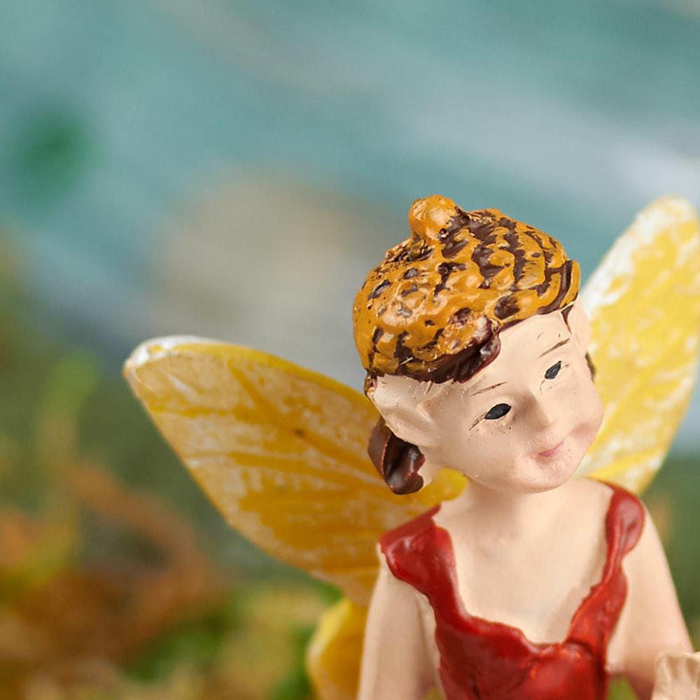 Scarlet the Woodland Fairy, a miniature fairy for the garden, displayed on a white background