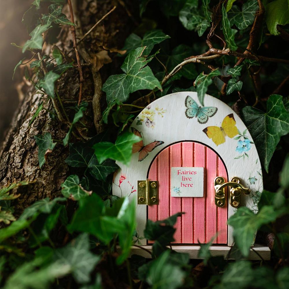 Truly Fairy Wooden Fairy Door, Fairy Themed Party Decoration, displayed against a tree trunk surrounded by ivy