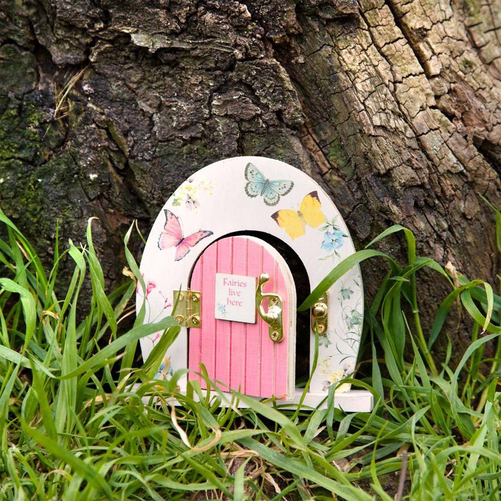 Truly Fairy Wooden Fairy Door, Fairy Themed Party Decoration, displayed against tree trunk amongst grass